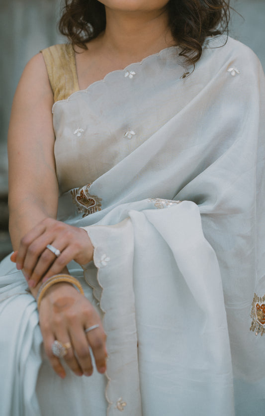 Cream & golden satin silk saree With orange gottapatti motifs