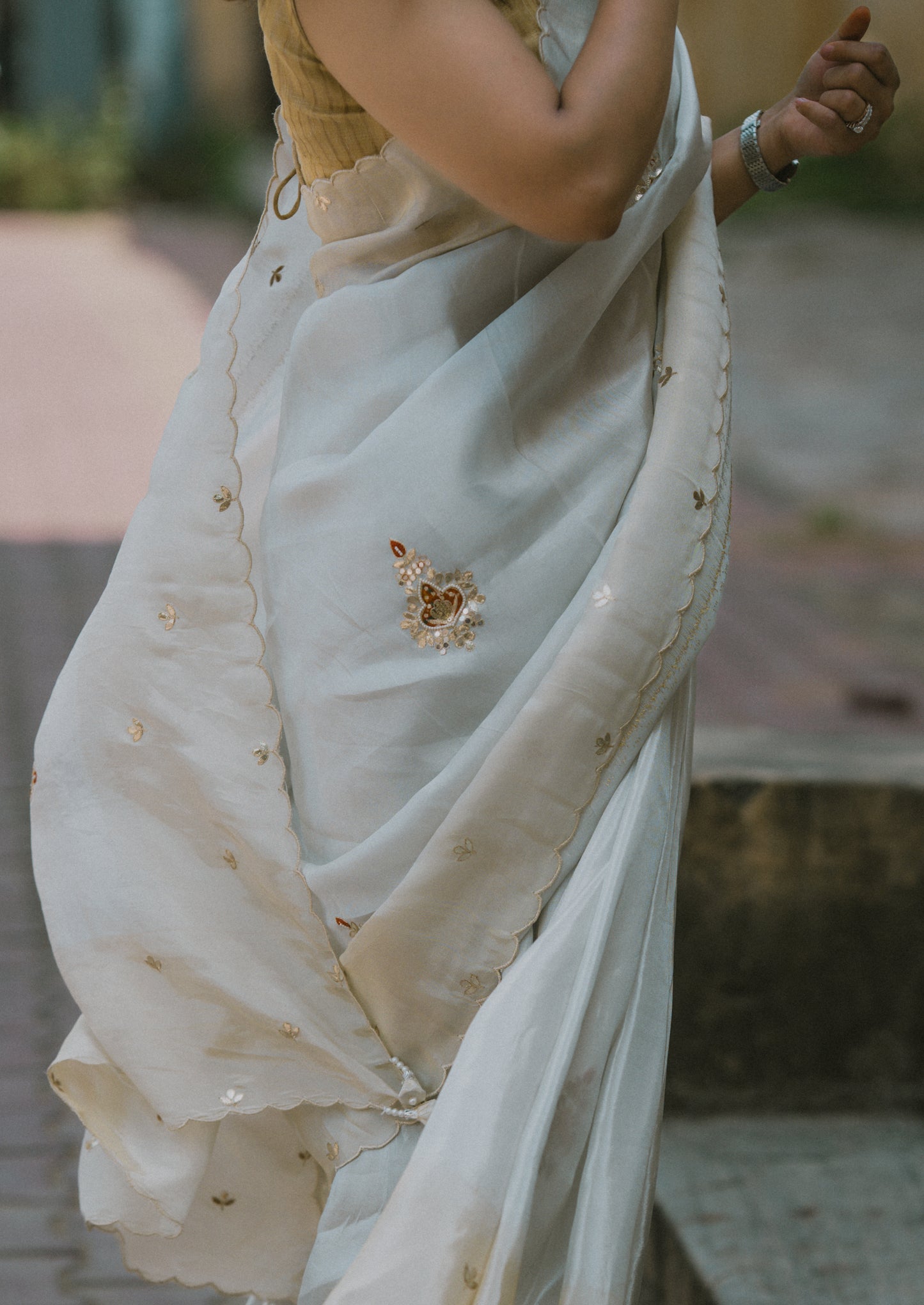 Cream & golden satin silk saree With orange gottapatti motifs